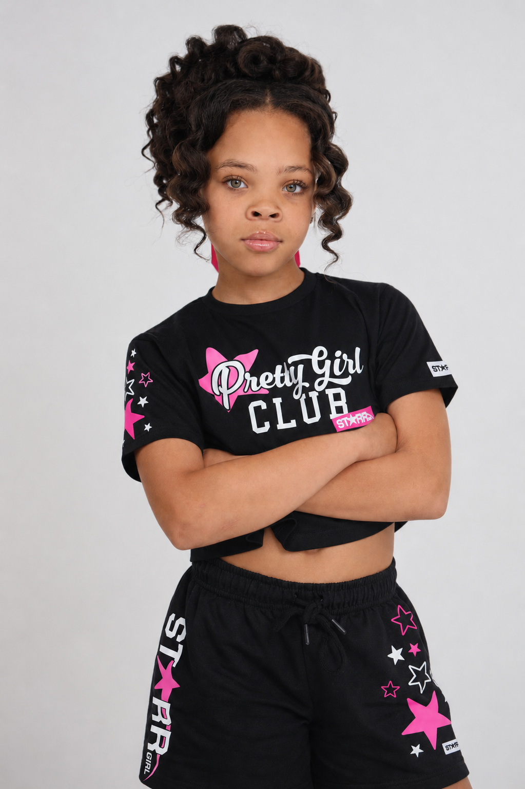 Black and pink Starr Girls Pretty Girl Club short sleeve crop top shown on a girl, casual style with vibrant color details.